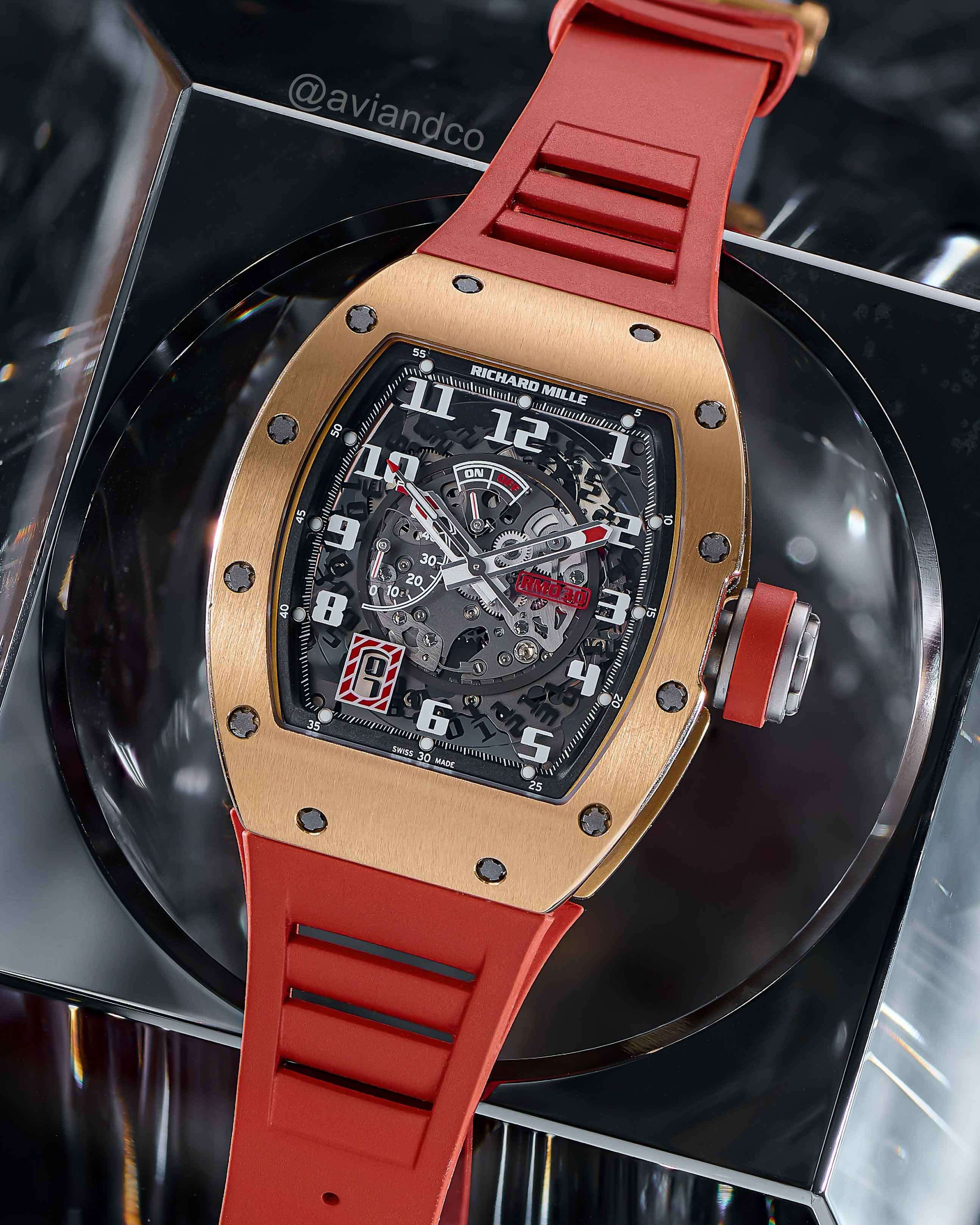 Richard Mille RM030, Rose Gold and Titanium, Transparent Dial Lying Flat on a Black Background