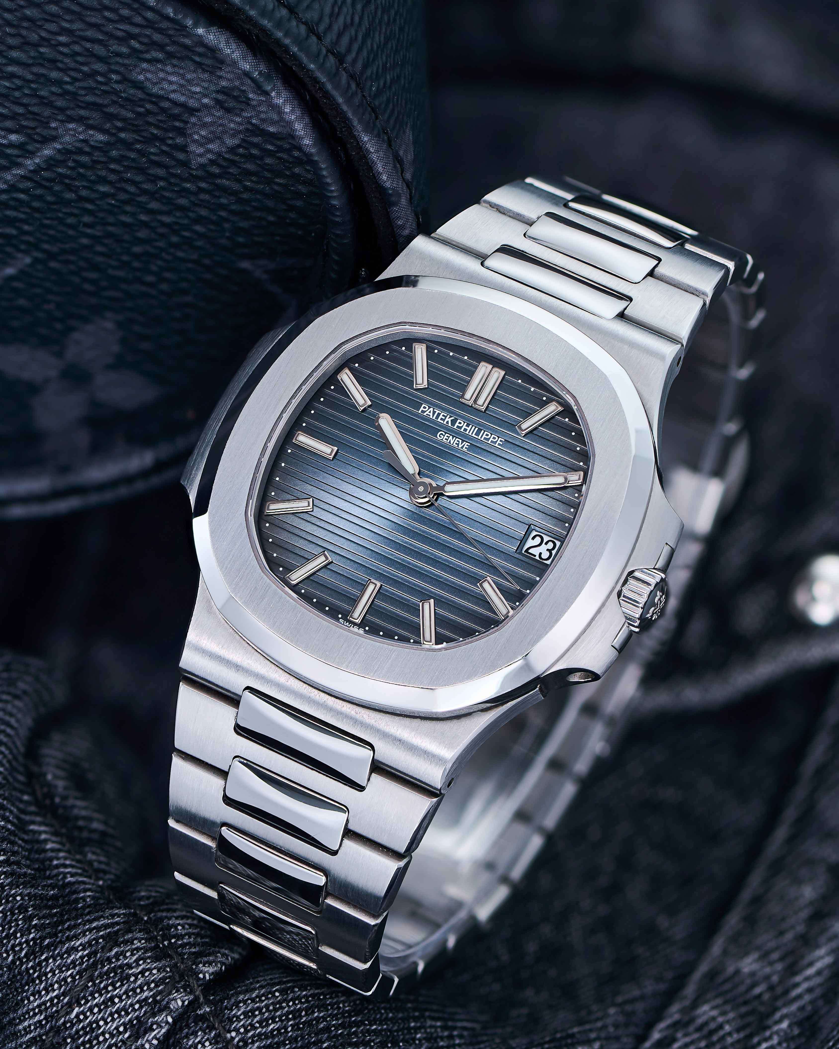 Patek Philippe Timepiece with Stainless Steel Bracelet on a Navy Jean Background