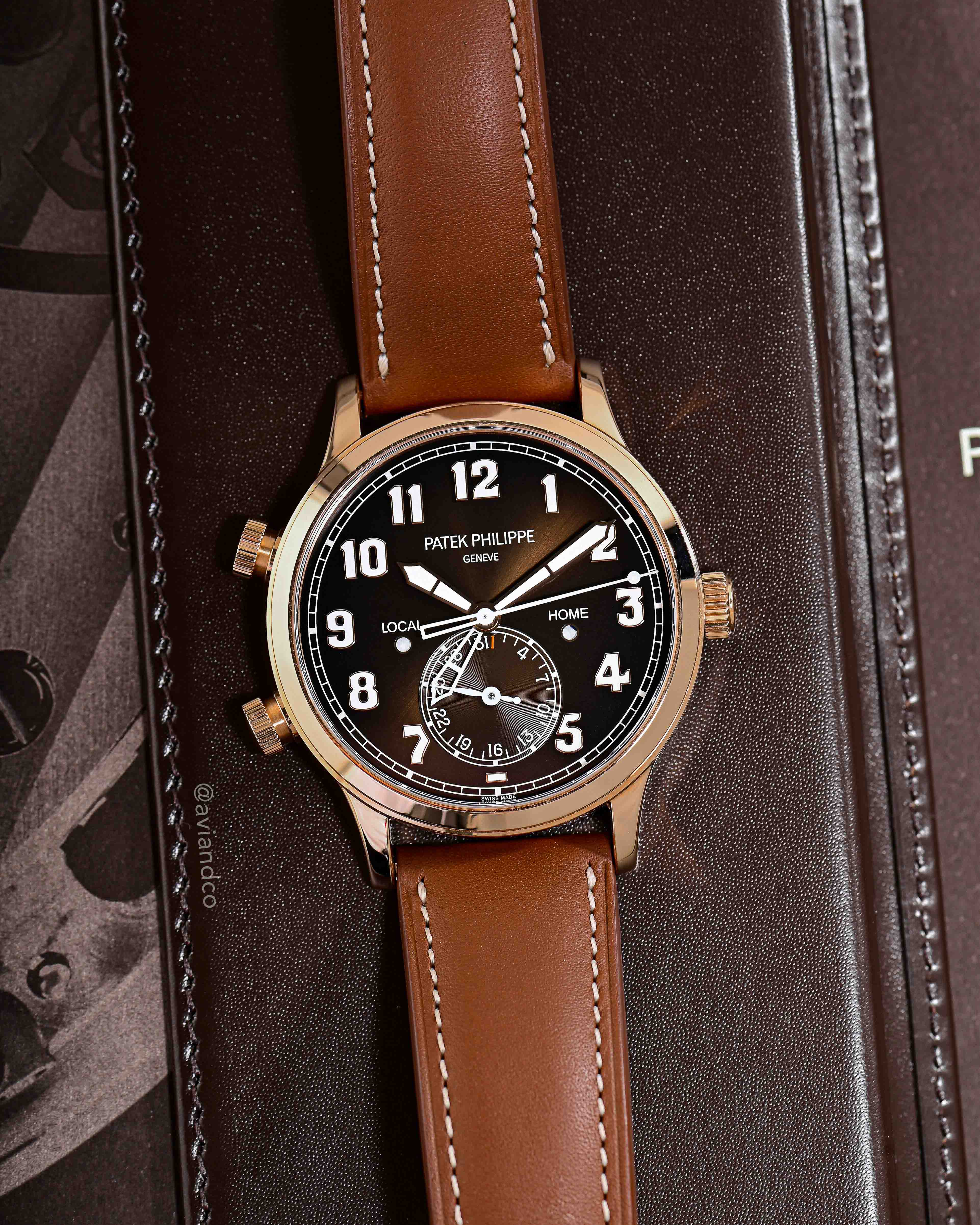 Brown Dial with Brown Leather Strap Laid out on a Brown Leather Background.