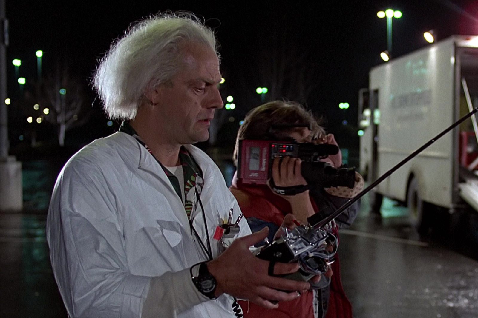 Movie Still from Back to the Future with Michael J. Fox’s Character Holding a Red Video Camera While Christopher Lloyd’s Character Holds a Controller