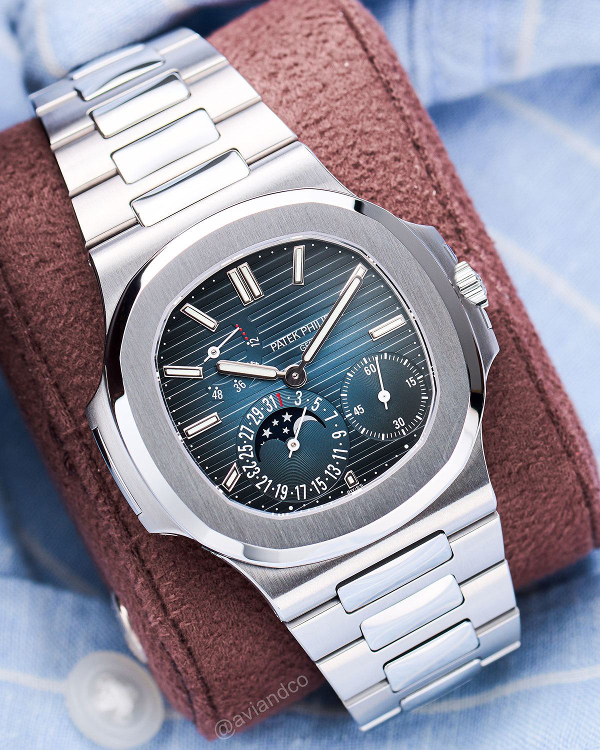 Stainless Steel 40 mm Case with Blue Dial, Stainless Steel Bracelet on a Brown Watch Roll