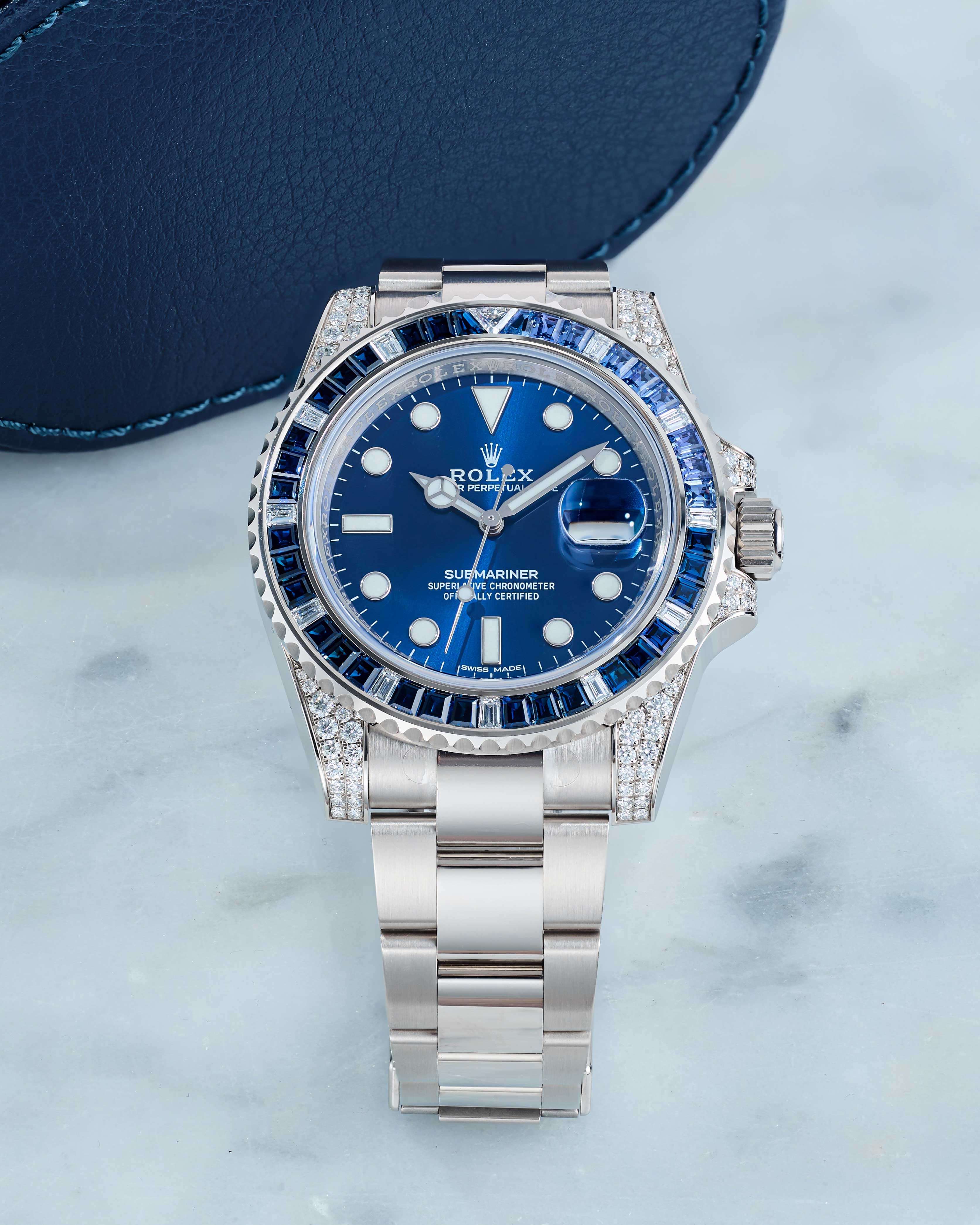 Rolex Submariner with an 18K White Gold 40 mm Case and Blue Diamond Sapphire Bezel on a White Marble Counter