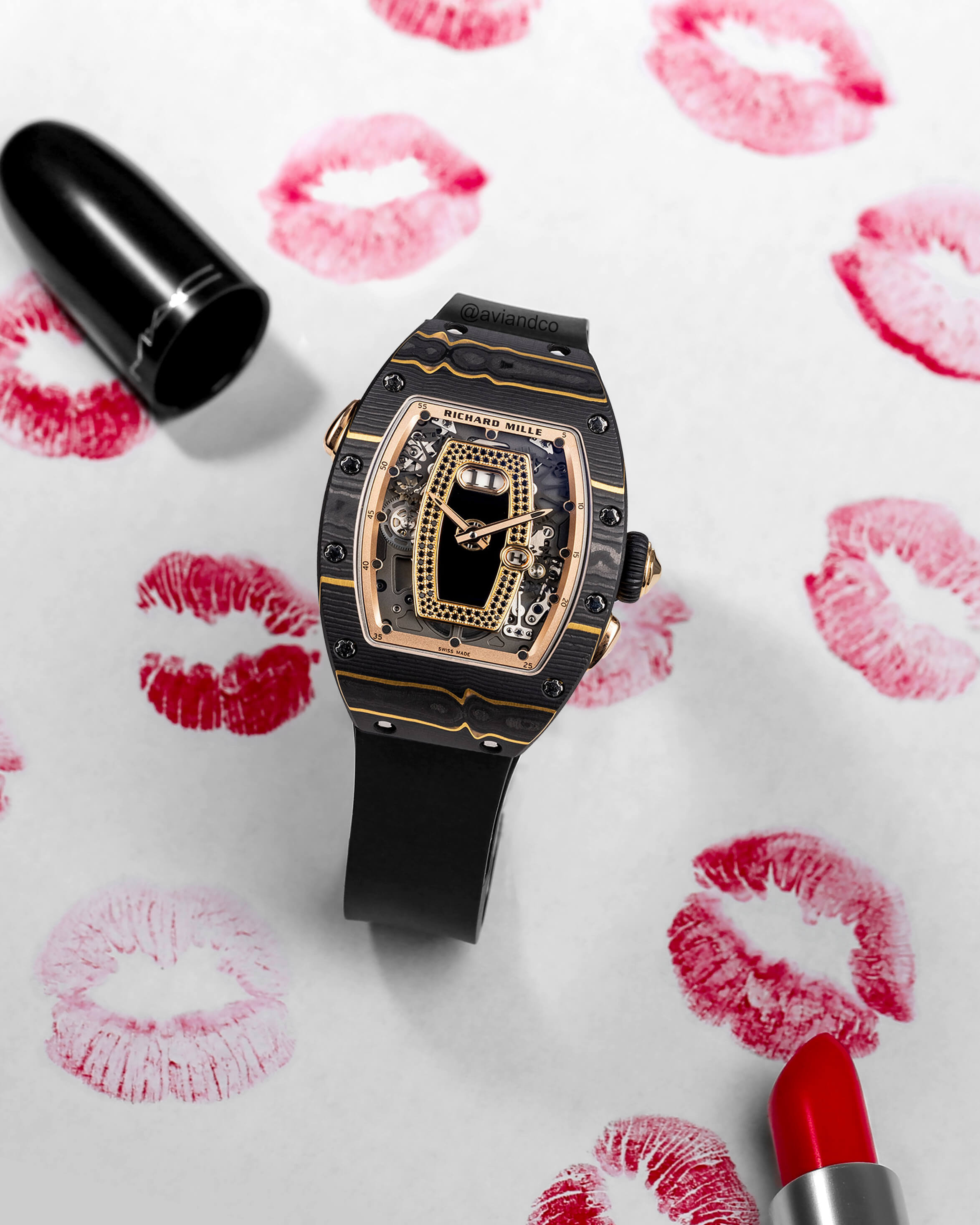 Richard Mille Black TPT Carbon Ladies Watch with Rubber Strap and 18K Rose Gold Bezel on a White Background with Red Lipstick Kiss Marks