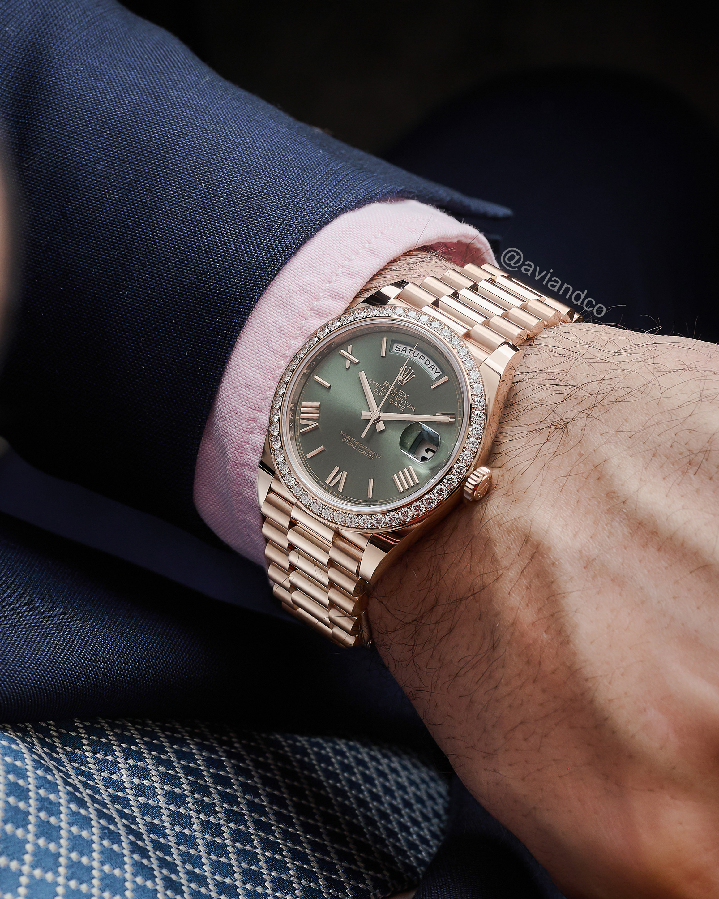 Rolex Day-Date on a Man’s Wrist Wearing a Navy Blue Suit and Pink Button-down