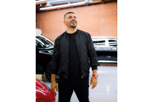 Avi & Co. Founder and CEO Avi Hiaeve Sporting a Red Richard Mille Watch Beside a Luxury Sports Car