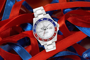 Rolex GMT-Master II White Meteorite Dial, blue and red bezel, atop a bed of ribbon, evoking holiday spirit and gifts