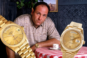 Tony Soprano pictured sitting at a table with gold Rolex Day Date watches in the foreground