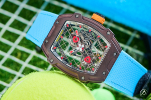 Richard Mille watch with blue strap on tennis net background with tennis ball