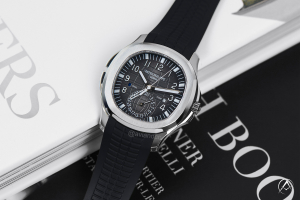Patek Philippe Aquanaut watch on top of books 