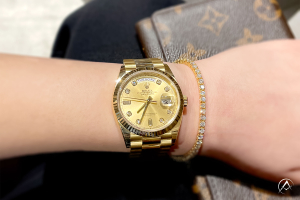 Rolex watch paired with gold tennis bracelet