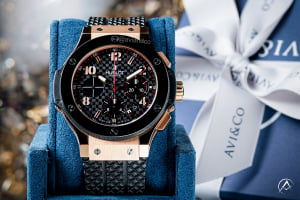 Hublot Big Bang watch on gift-giving background with blue and white boxes featuring the Avi & Co. logo 