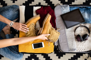 Woman wearing Richard Mille RM 07-01, 18K Rose Gold, Array of Diamonds while packing a suitcase