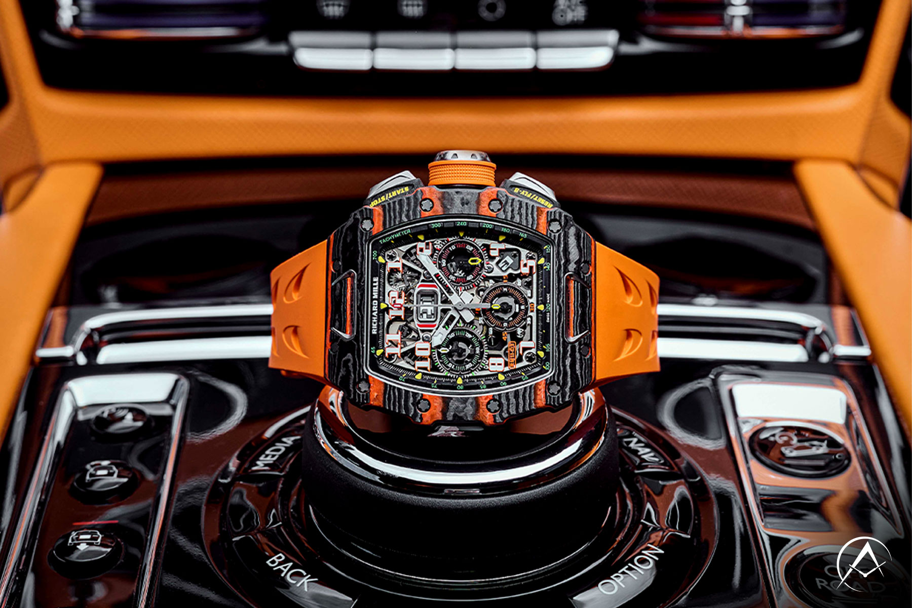 Carbon 44 mm Richard Mille McLaren Timepiece Assembled with Quartz TPT Bezel and Orange Rubber Strap and Skeleton Dial Inside of an Orange and Black Car.