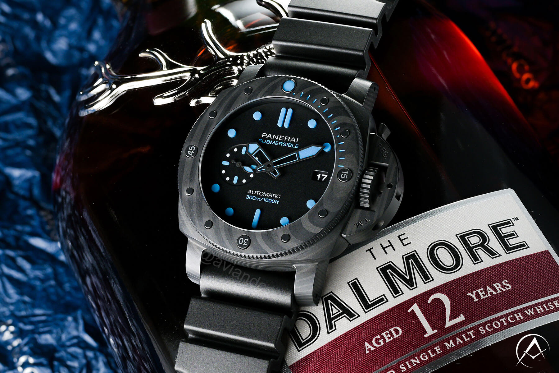 42 mm Carbon Panerai Submersible Luxury Watch with Black Dial, Luminous Dot Hour Markers, Rubber Bracelet, and a 1,000 Foot Water Resistance.