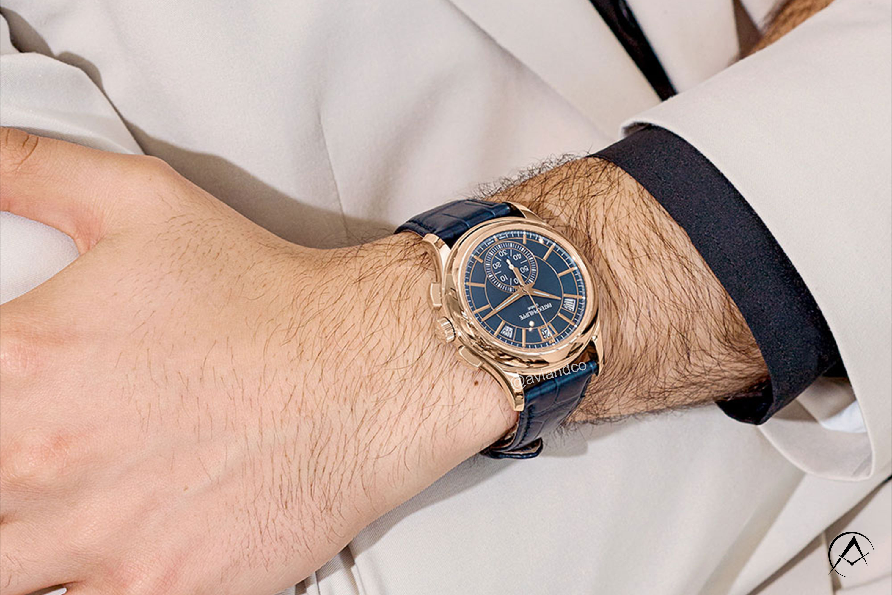 Patek Philippe Complications watch in navy blue paired with tan suit
