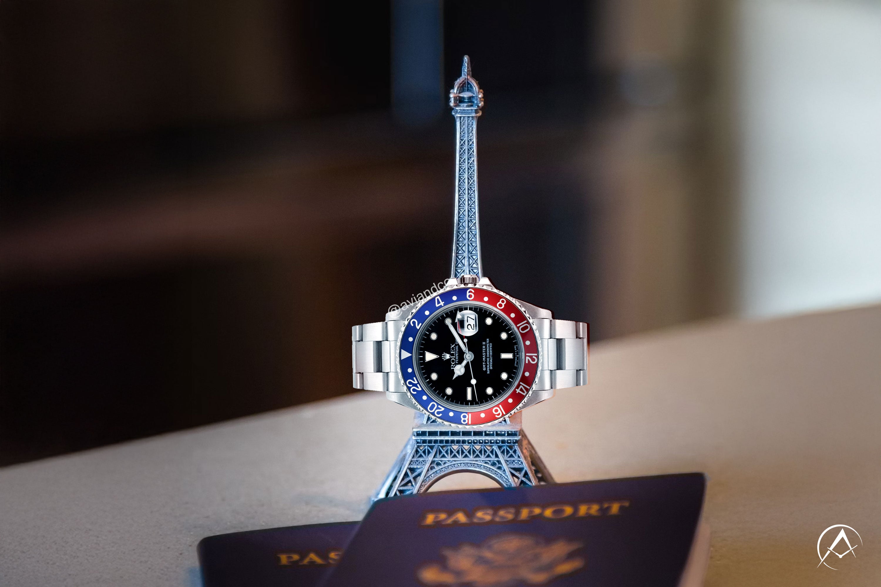 Rolex GMT-Master II watch on a model of the Eiffel Tower