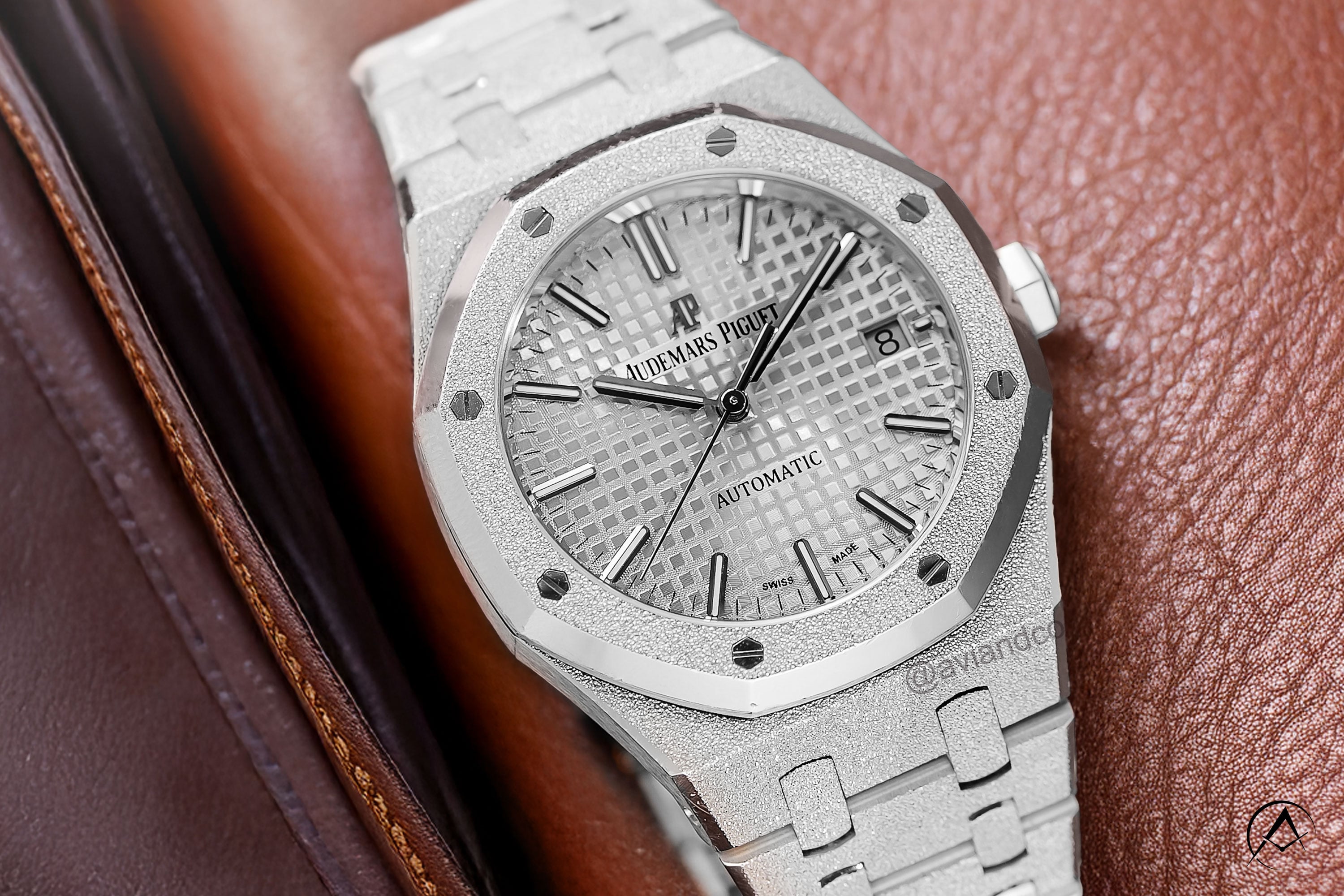 Audemars Piguet Royal Oak, 18K White Gold, Silver Dial, 33 mm on cognac leather background