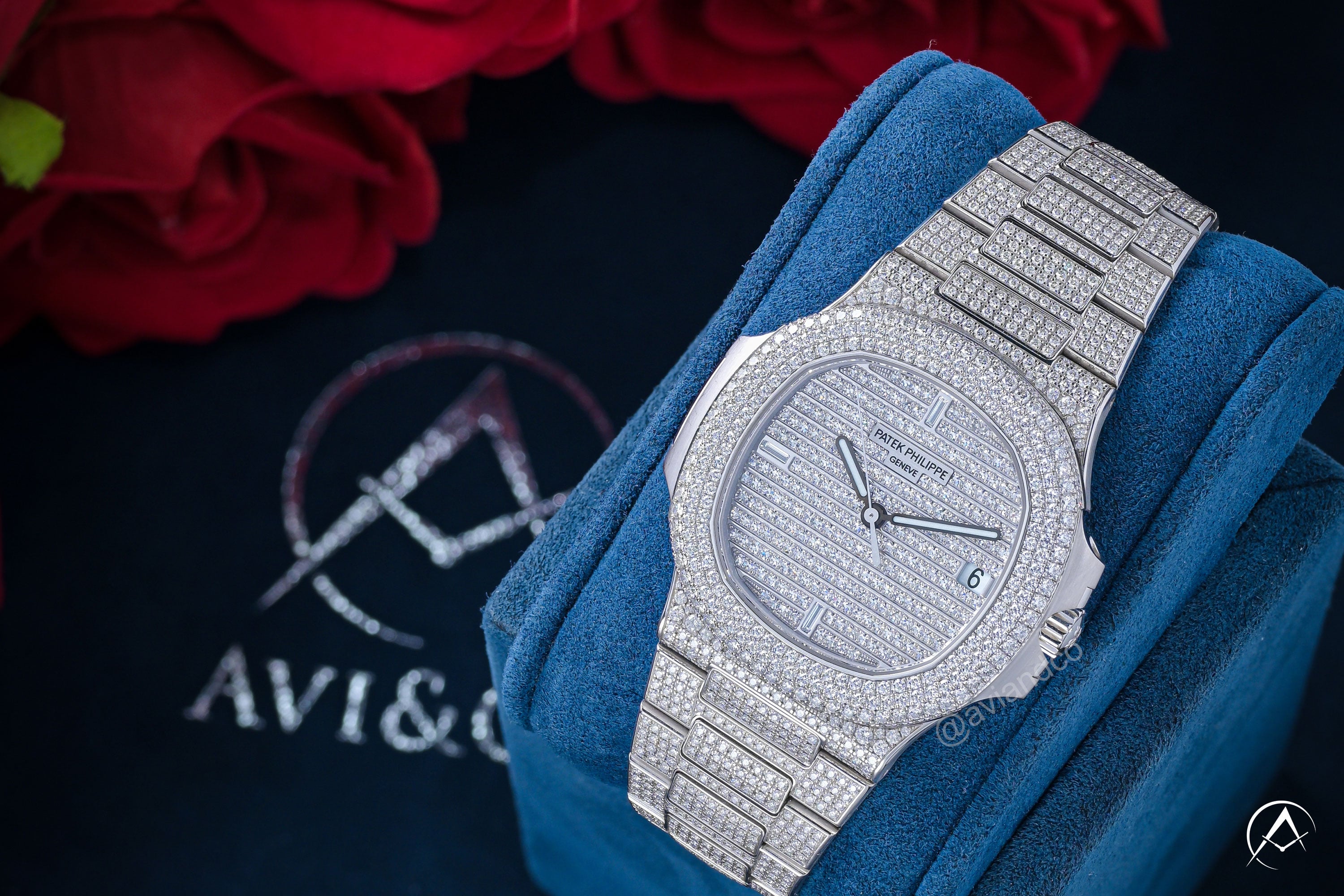 Patek Philippe Nautilus diamond pave watch in blue box with roses in the background