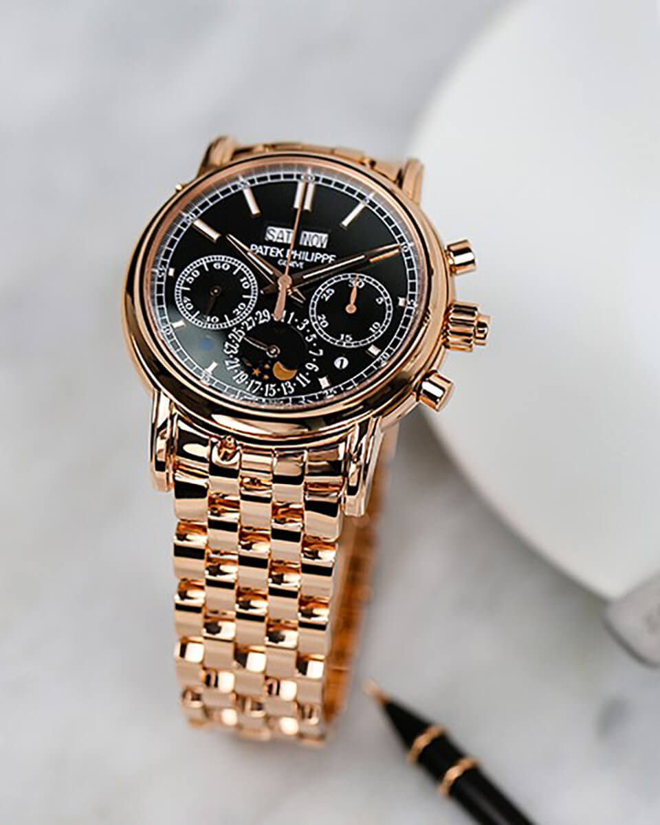 Patek Philippe Grand Complications with Black Dial, 3 Subdials, with Rose Gold Bezel and Bracelet on a White Background