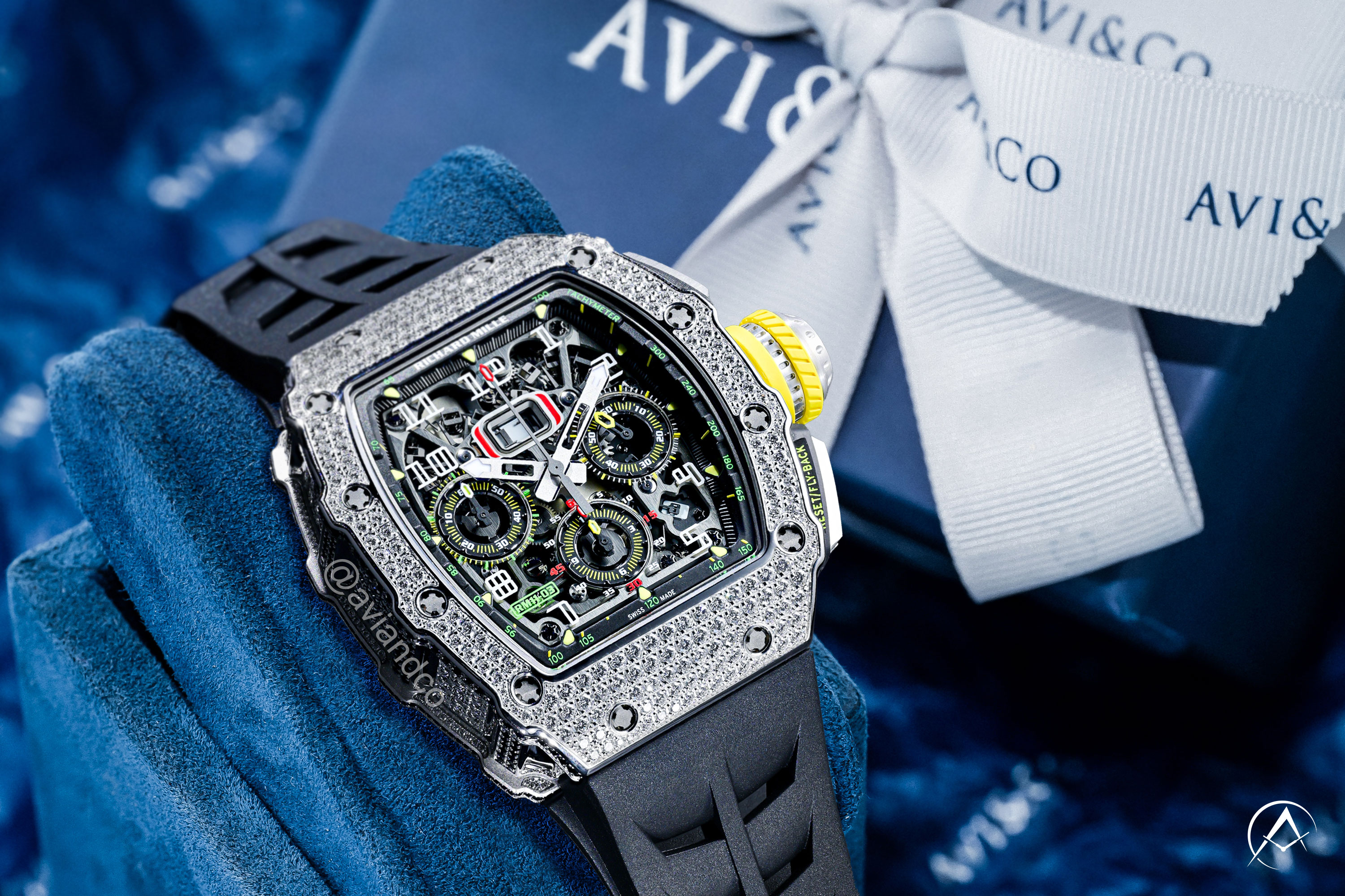 Richard Mille RM 11-02 watch with diamond bezel on gift-giving background featuring Avi & Co. boxes