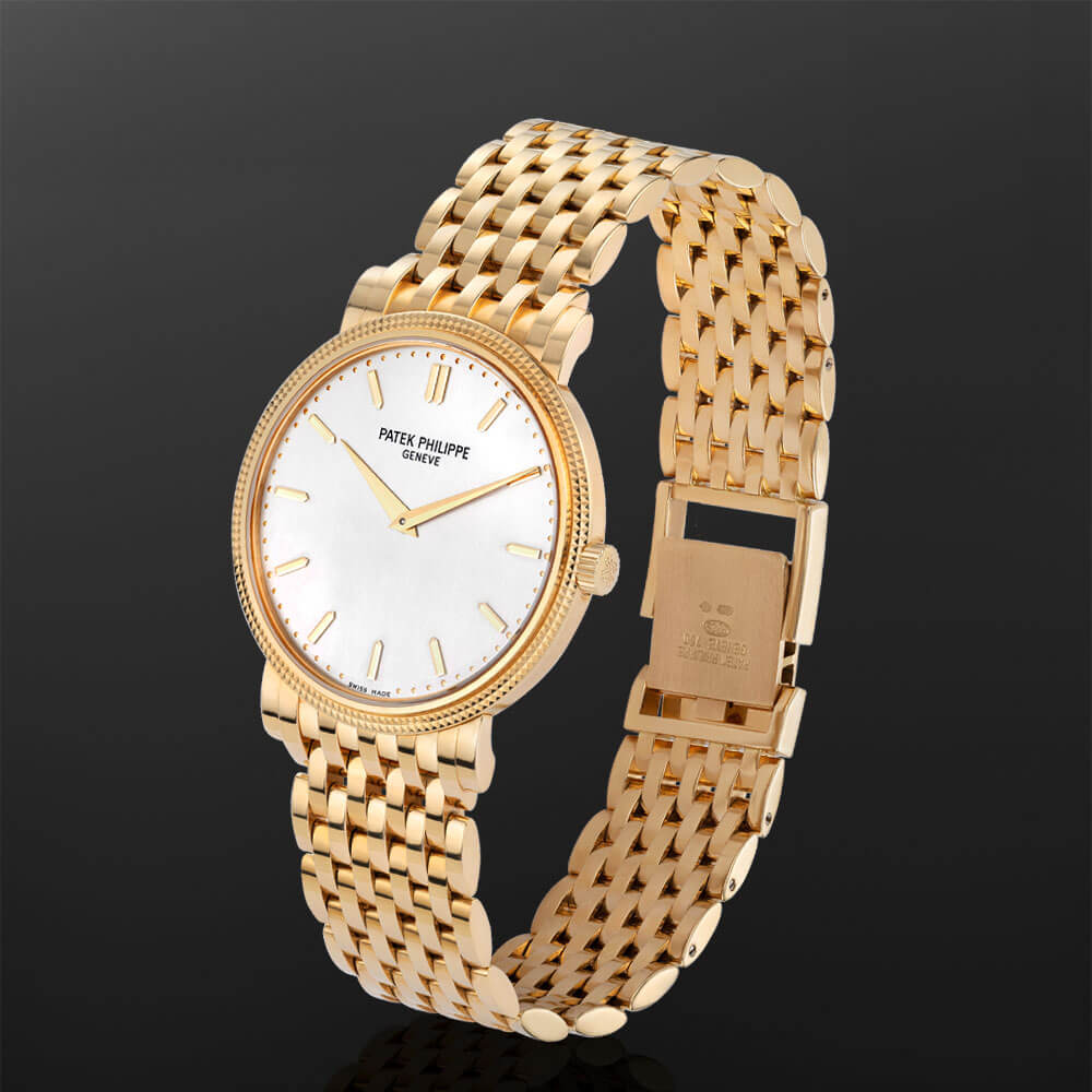 35 mm 18K Yellow Gold Patek Philippe Calatrava Watch with Silver Index Dial and Yellow Gold Bracelet.