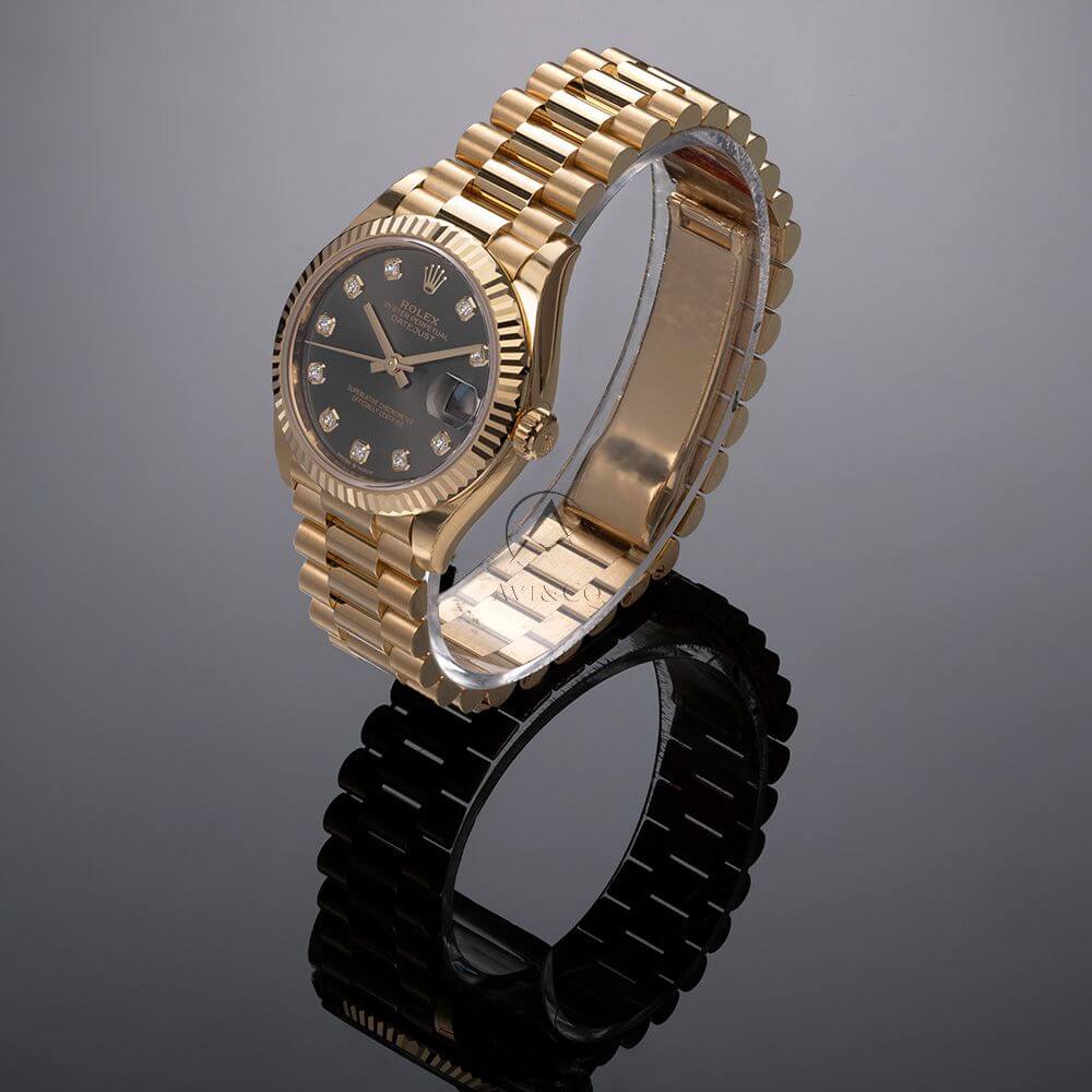 18K Yellow Gold 31 mm Rolex President Day-Date with Dark Grey Dial and Diamond Index Markers.