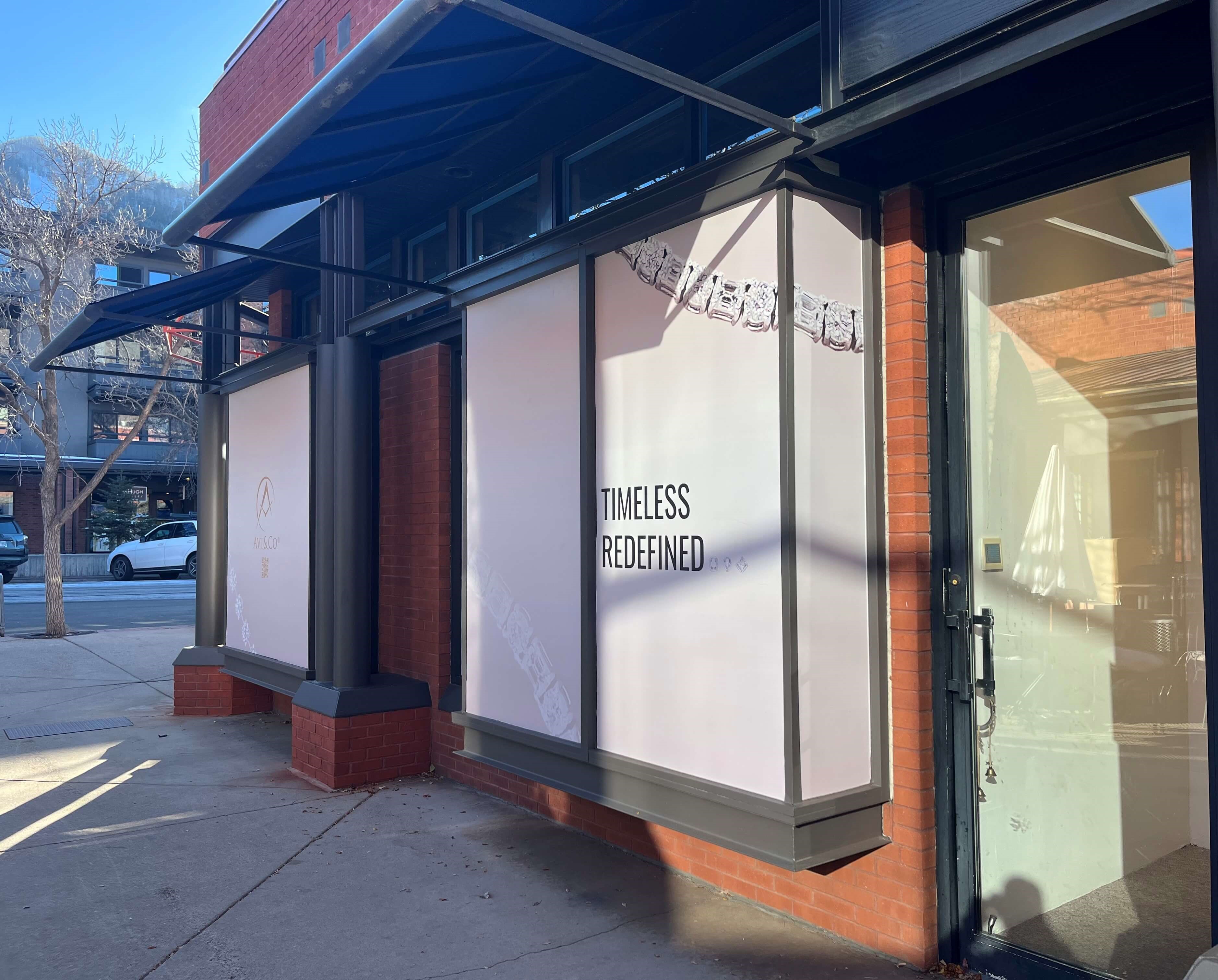 Luxury Storefront with Diamonds in Front Window Reading ‘Timeless Redefined’ That will sell Luxury Watches and Jewelry.