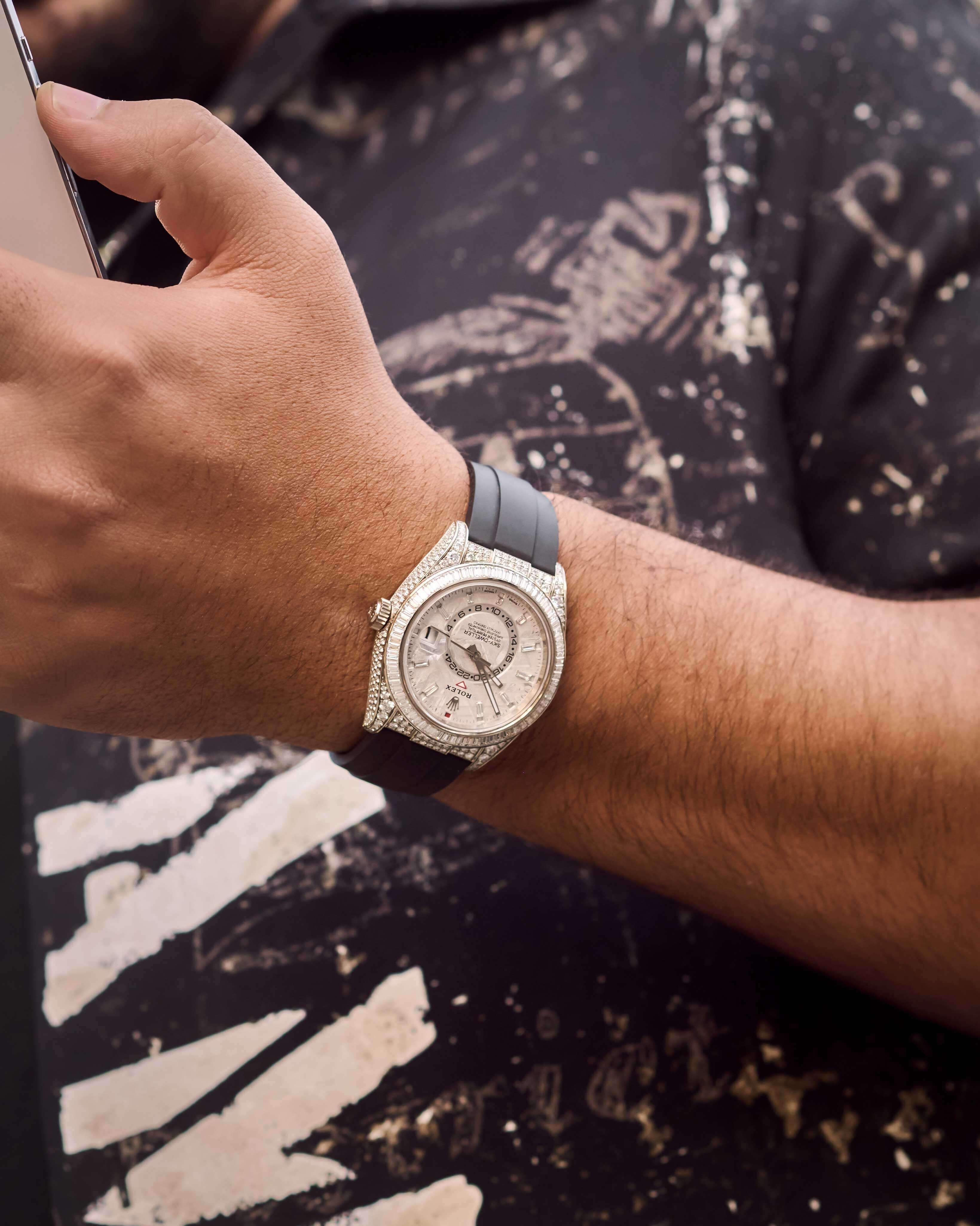 Avi Hiaeve, CEO and Founder of Avi & Co., Wears a White Gold Diamond-Pave Timepiece with Black Rubber Strap Around his Wrist.