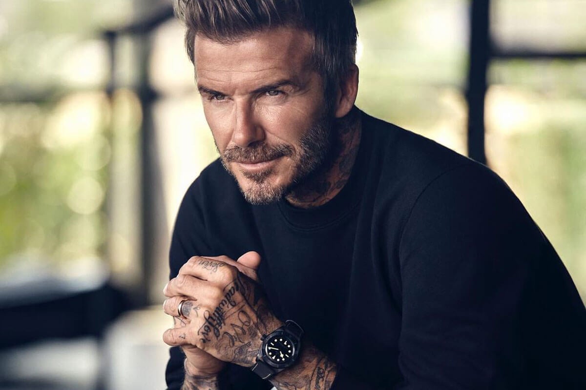 Professional Soccer Player Poses in a Black Shirt and Wears a Black Ceramic Timepiece Around his Wrist.
