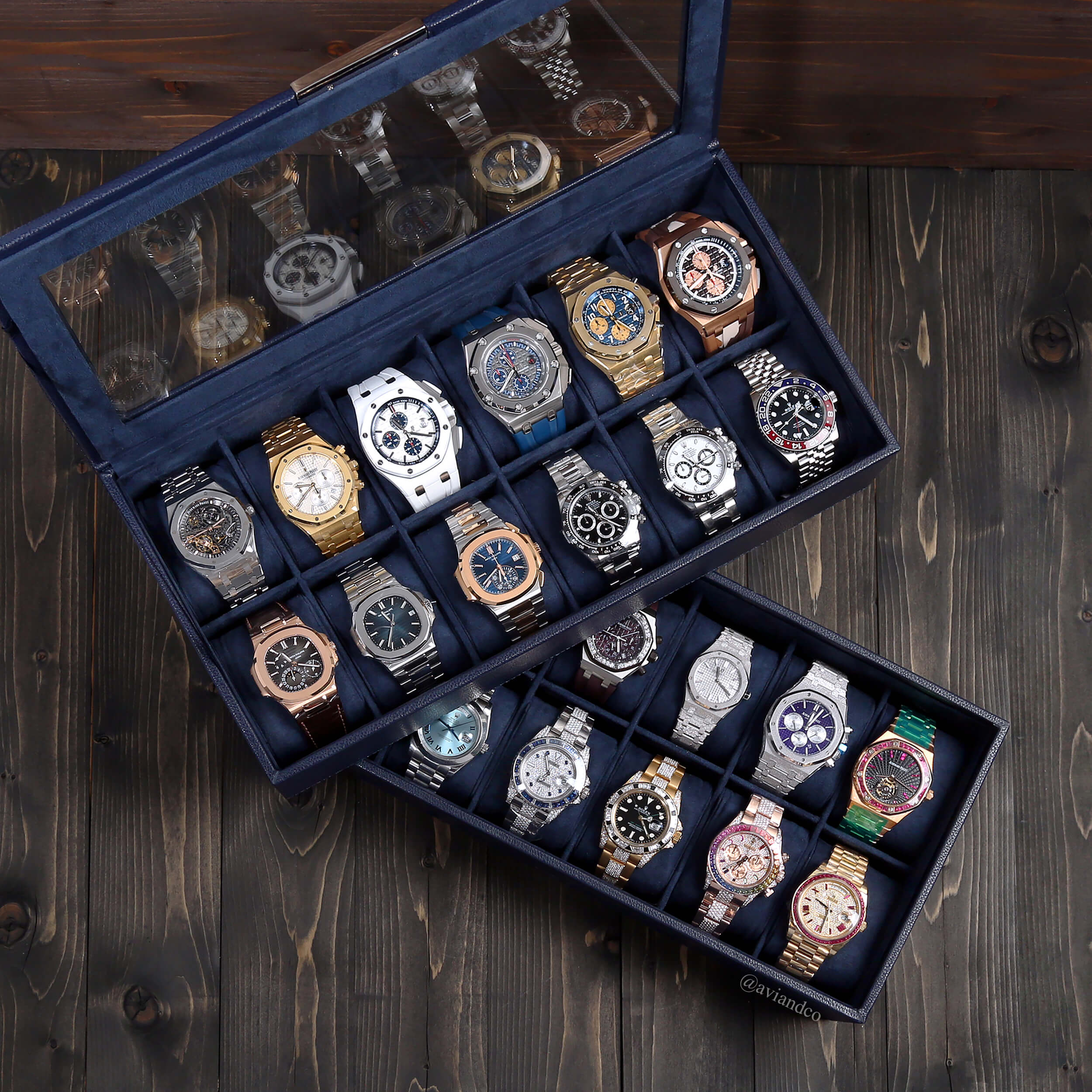 21 Luxury Timepieces, Some with Diamonds, Displayed in Watch Boxes on a Wooden Table.