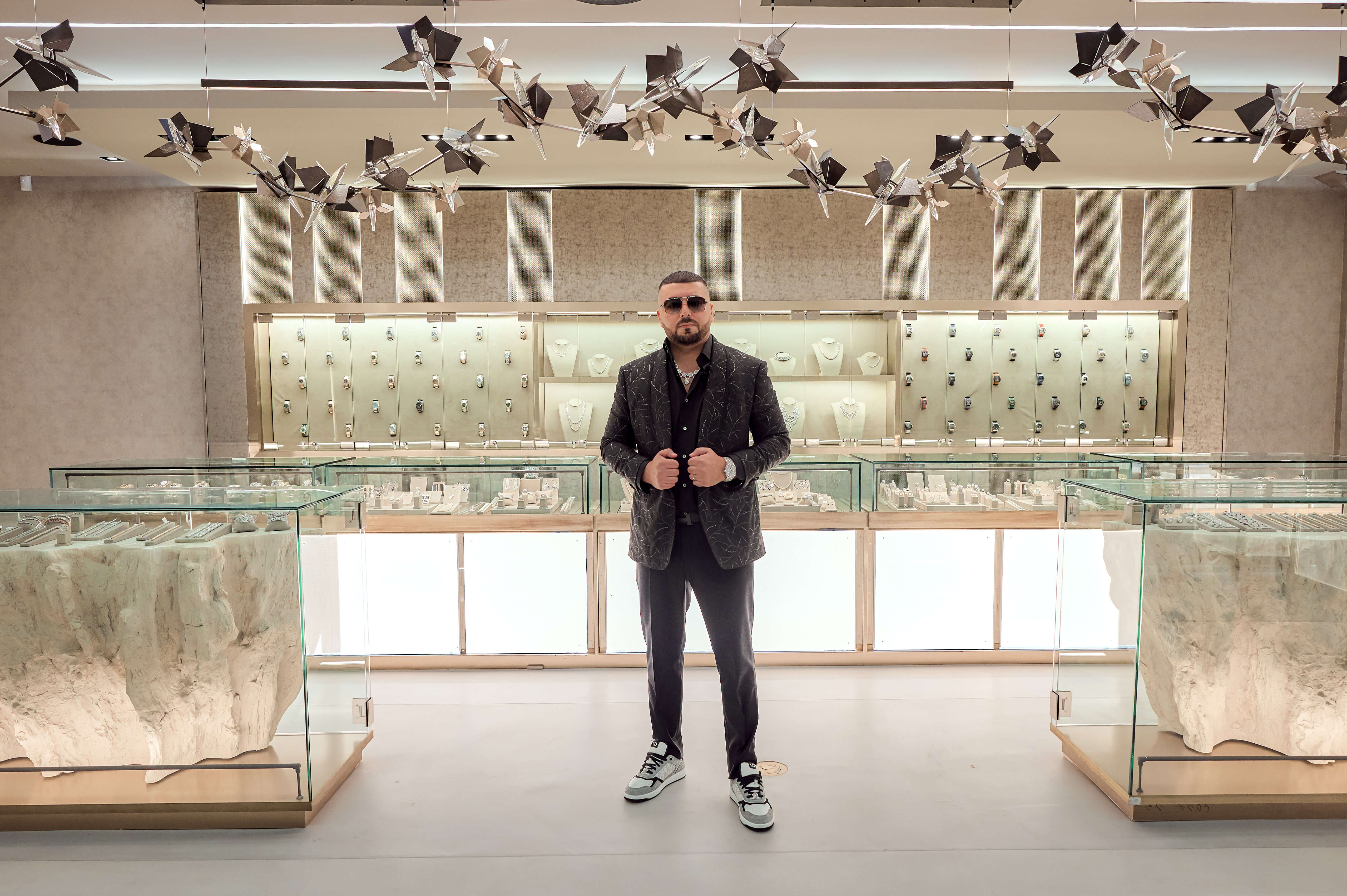 CEO and Founder of Avi & Co. Standing in his Miami Boutique, Surrounded by Luxury Watches and Diamond Jewelry.