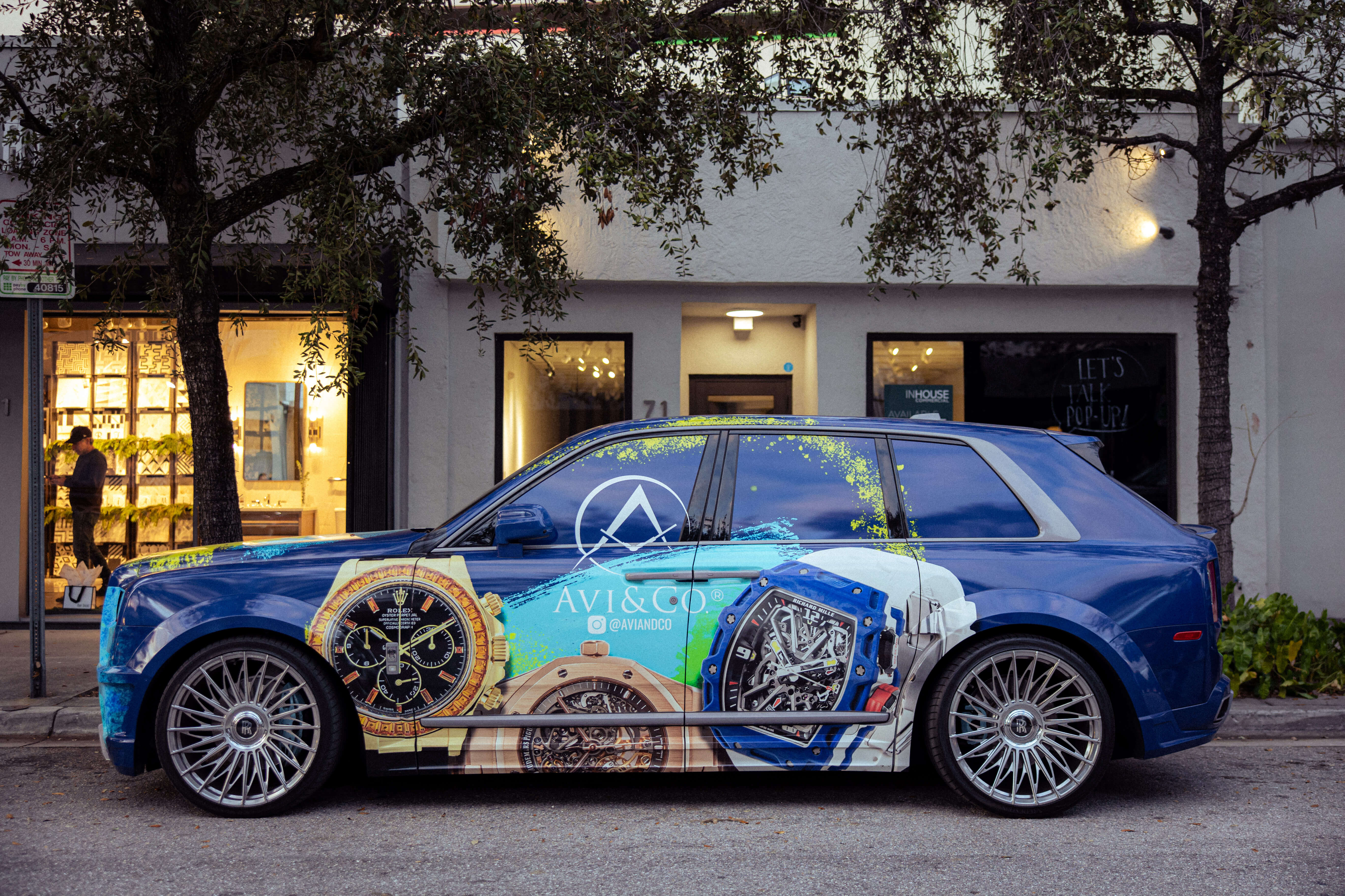 Luxury Car Outside of the Miami Boutique Decorated in Blue with a Rolex Daytona, Richard Mille, and Audemars Piguet Luxury Timepiece.
