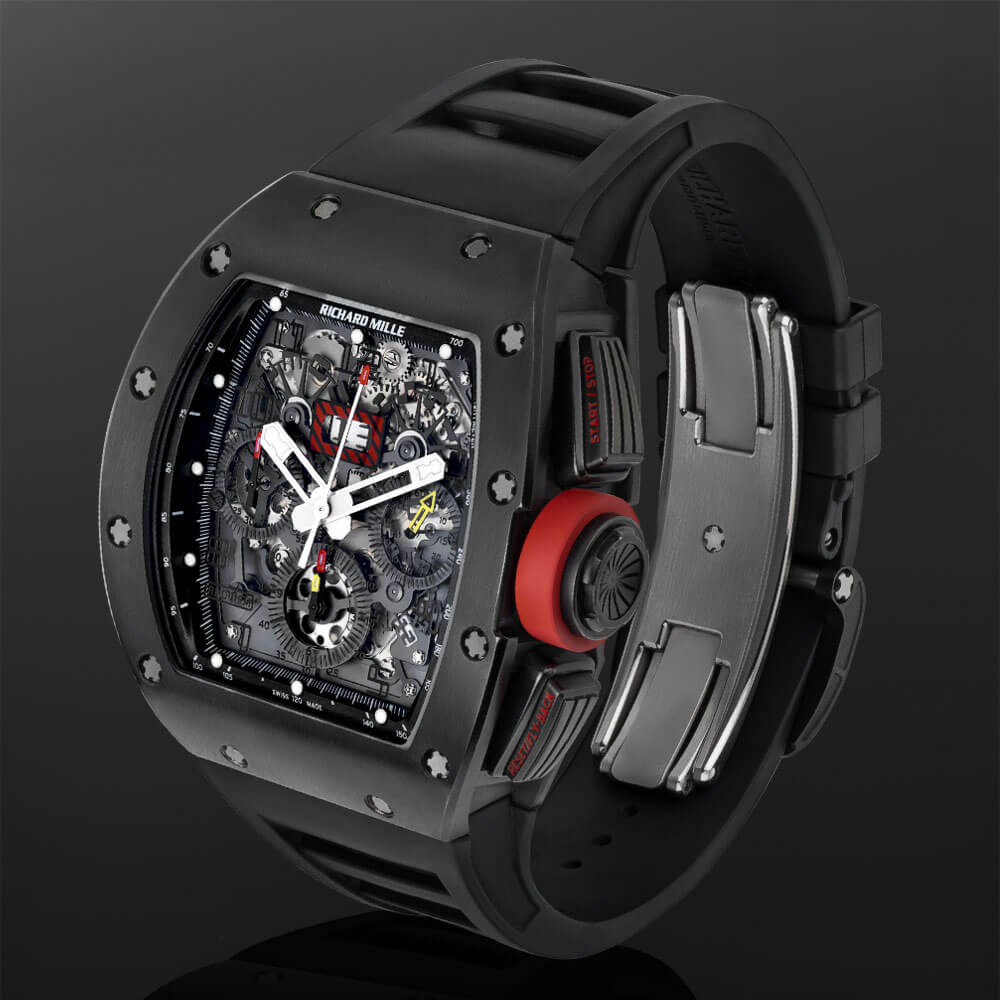 Titanium Case and Openworked Dial Richard Mille Timepiece with Black Rubber Strap Displayed on a C-Ring with a Black Background.