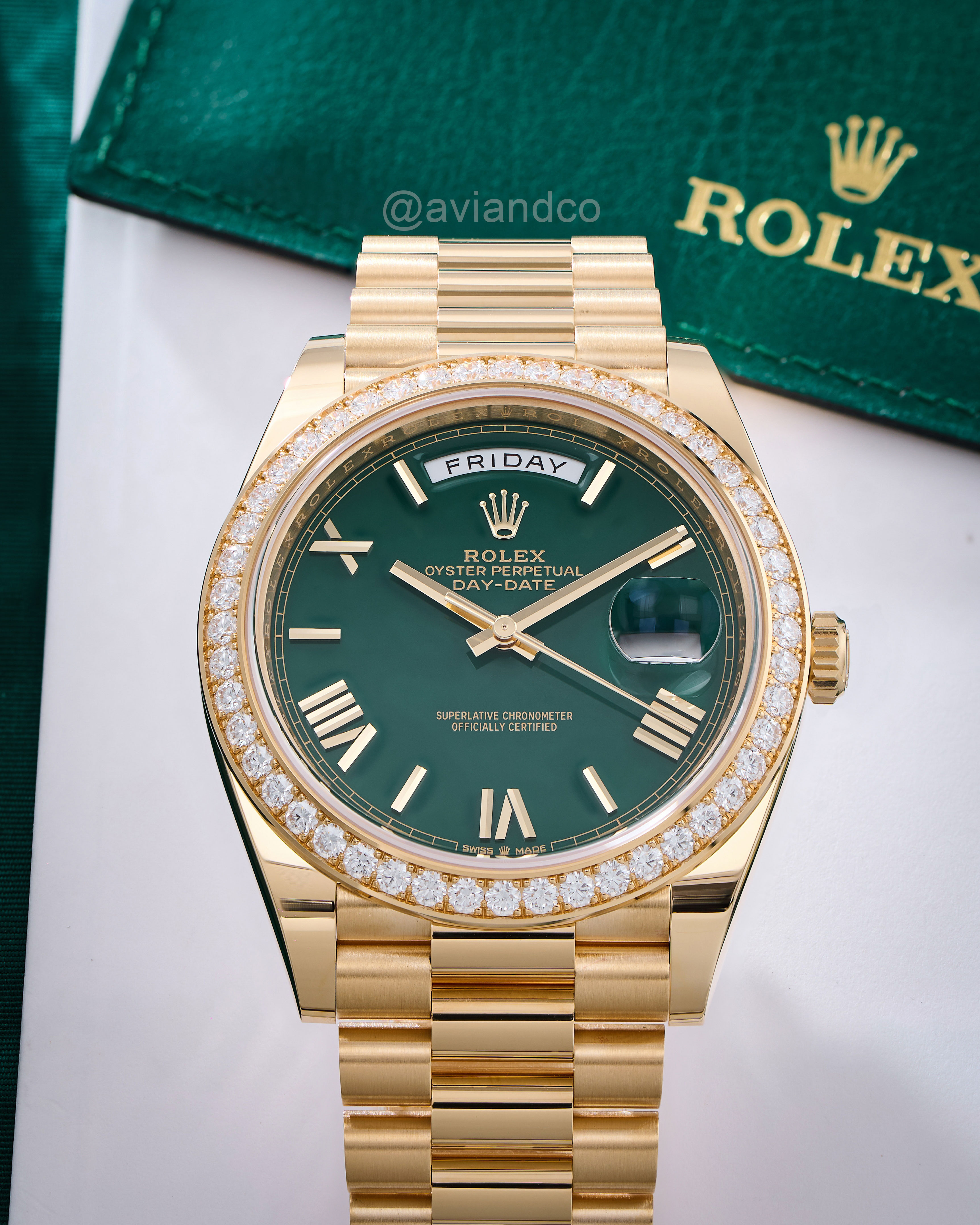 Green Dial with Diamond-Bezel Timepiece with Roman Numerals on a White Background.