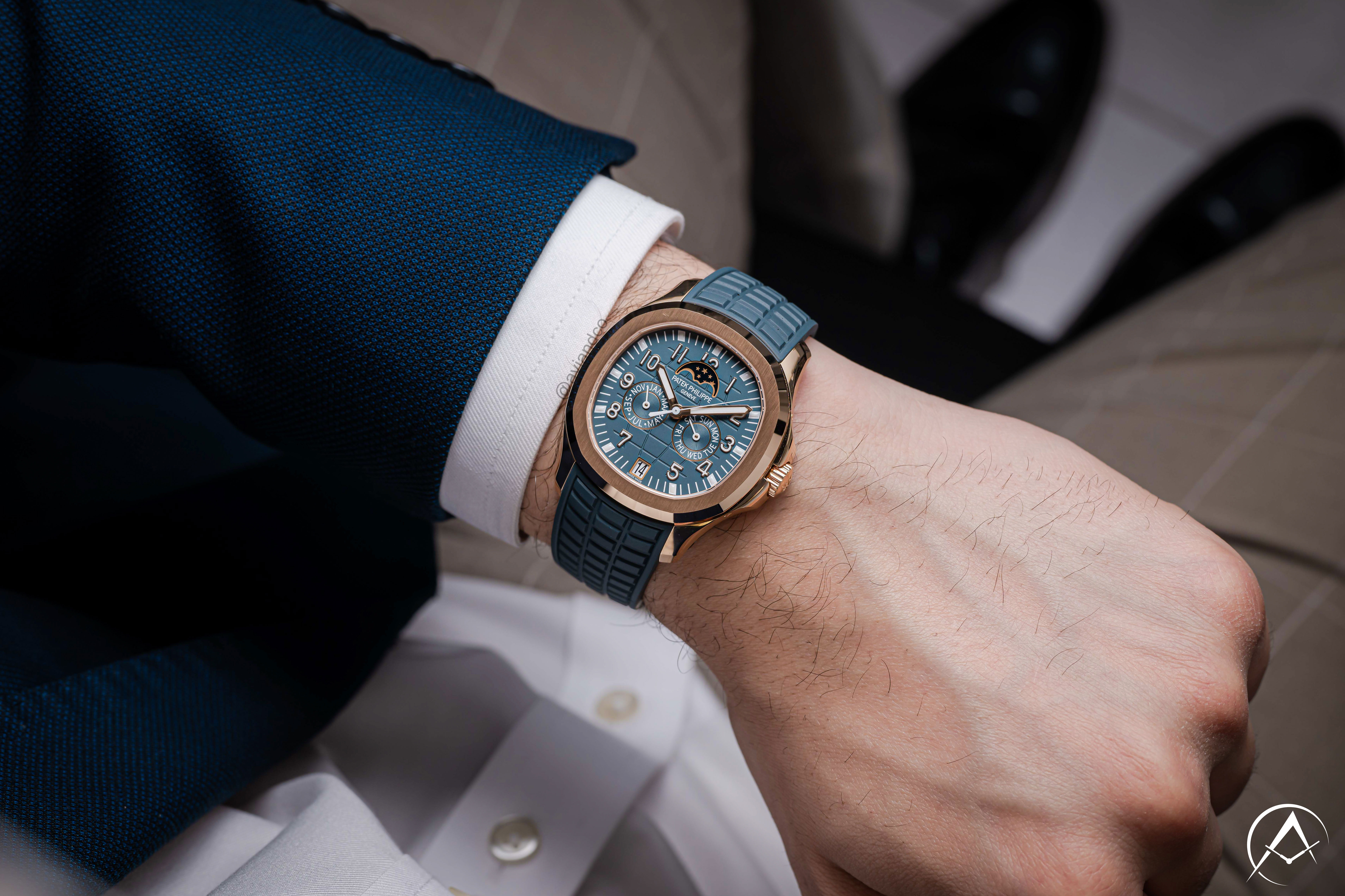 18K Rose Gold Luxury Timepiece with Blue Dial, Arabic Numerals, Navy Blue Rubber Strap, and Annual Calendar Displayed on a Man’s Wrist.