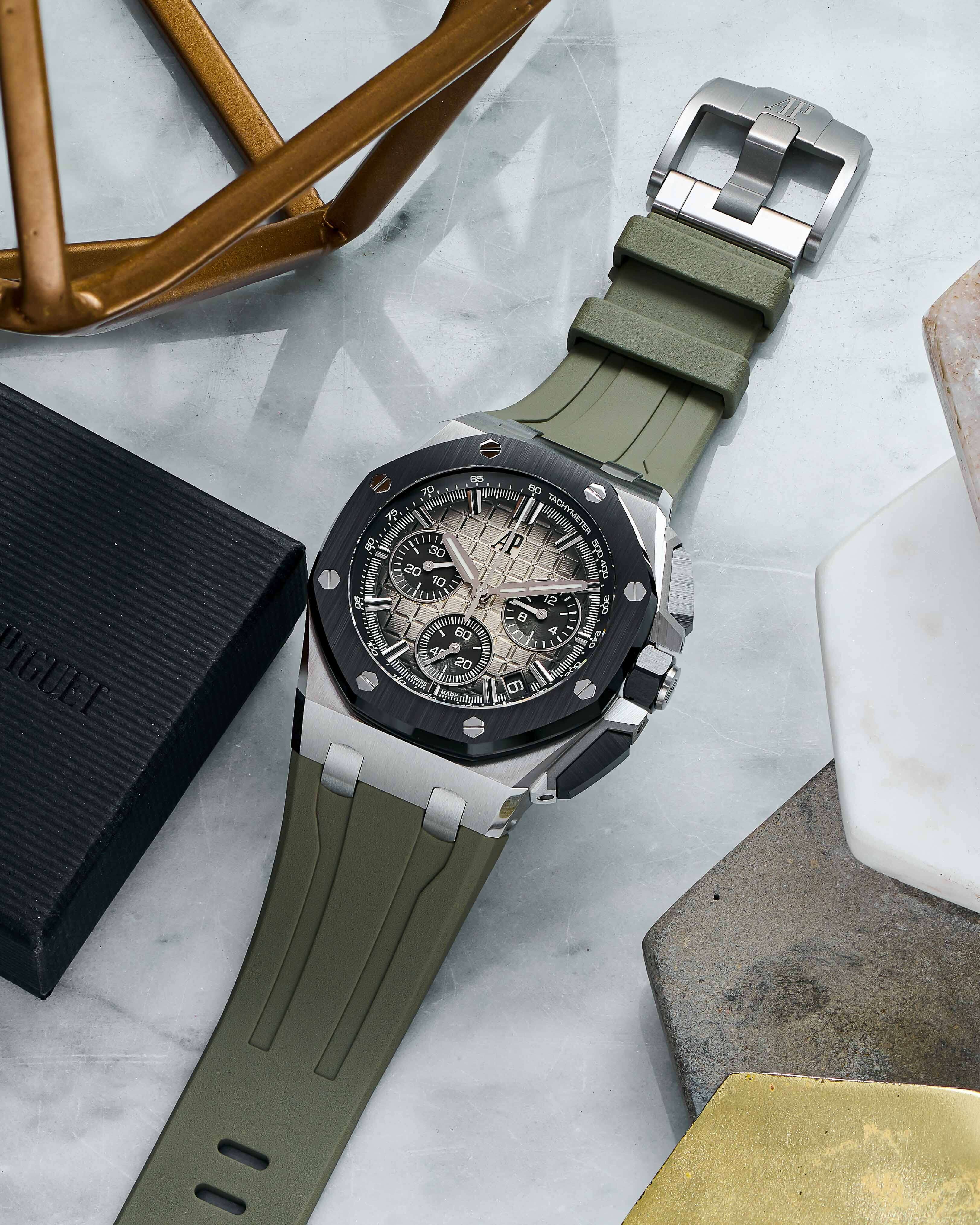 Stainless Steel Audemars Piguet Royal Oak Offshore Chronograph with 43 mm Dial, Brown Mega Tapisserie Dial, Green Rubber Bracelet, and Date Function.