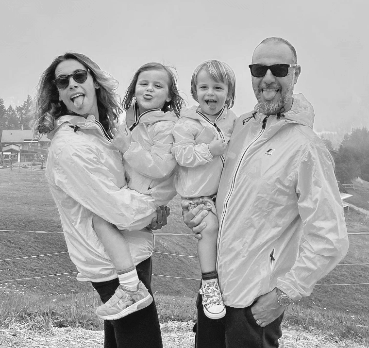 Giorgia Mondani, her Husband, Daughter, and Son make Silly Faces on a Field.