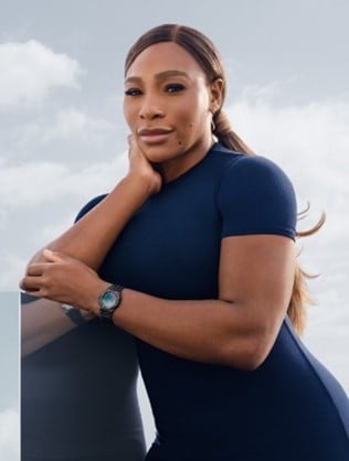 Woman Wearing Navy Dress Posing with an Audemars Piguet Timepiece Around her Wrist.