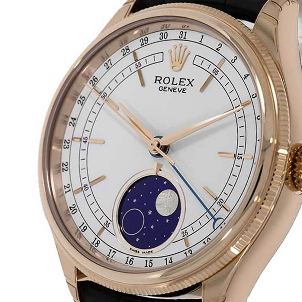 Closeup of a White Dial Timepiece with Fluted Bezel and Moonphase Function on a White Background.