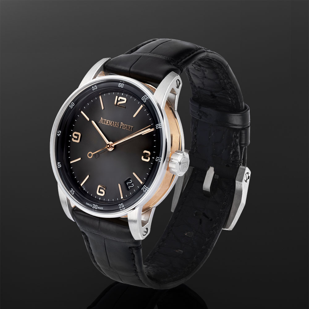 Rose Gold Audemars Piguet Code 11.59 Timepiece with Black Leather Strap Displayed on a C-Ring with a Black Background.