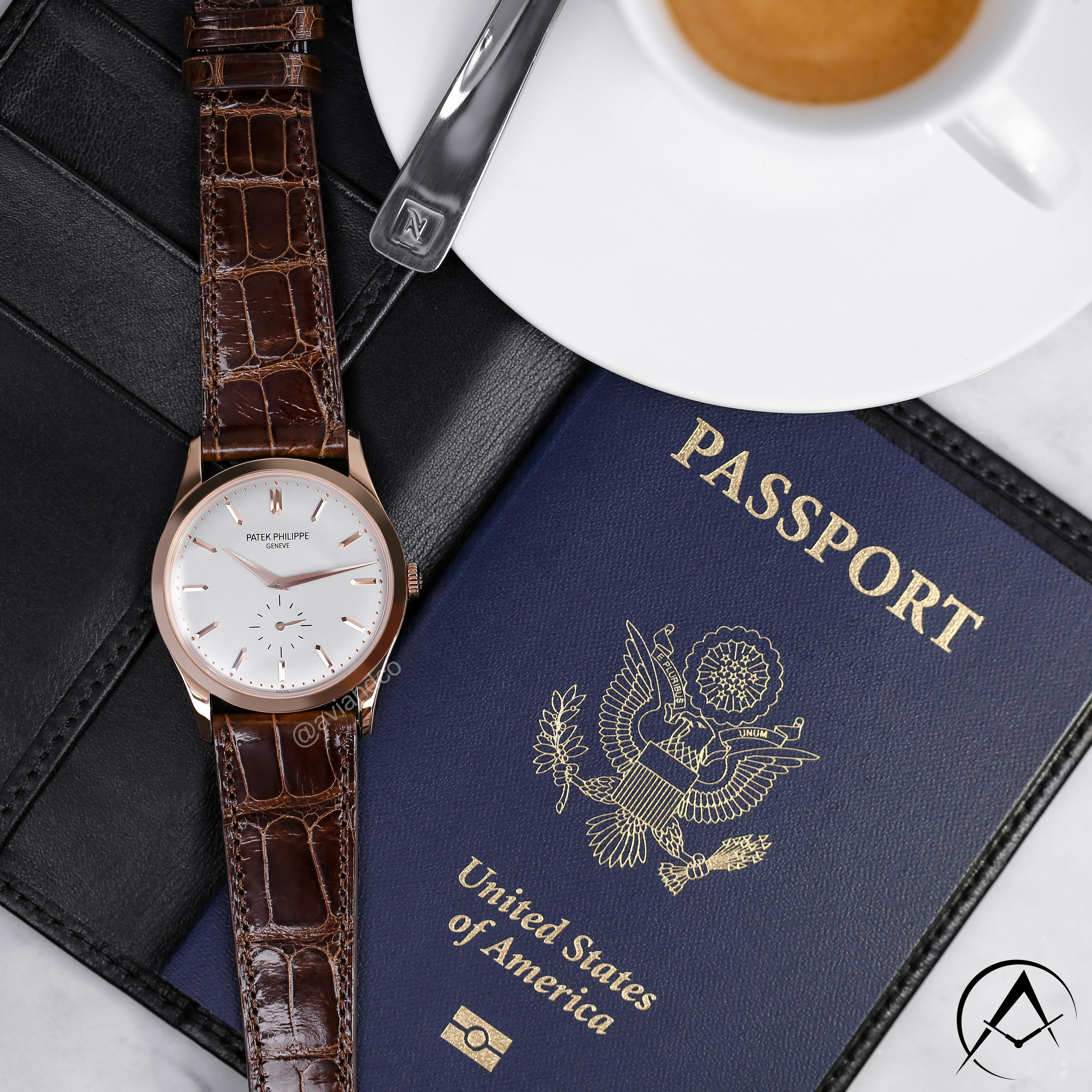 37 mm Yellow Gold Timepiece with Index Hour Markers, White Dial, and Leather Bracelet Displayed Beside a Passport and Cup of Coffee.