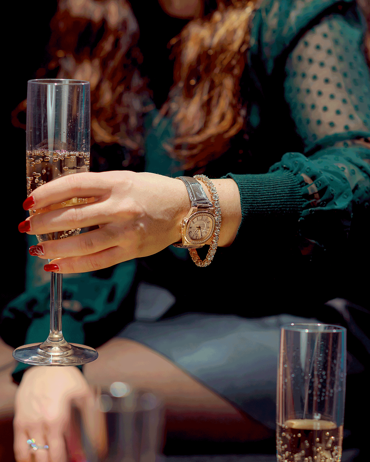 18K Rose Gold Luxury Timepiece with Diamond Bezel and White Index Dial on a Woman’s Wrist Holding a Glass of Champagne.