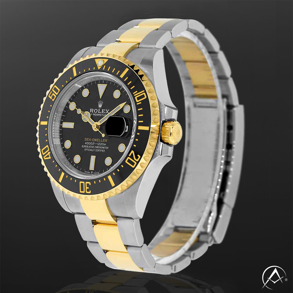 Stainless Steel Timepiece with Black Dial and Black Bezel Displayed on a Clear C-Ring on a Black Background.