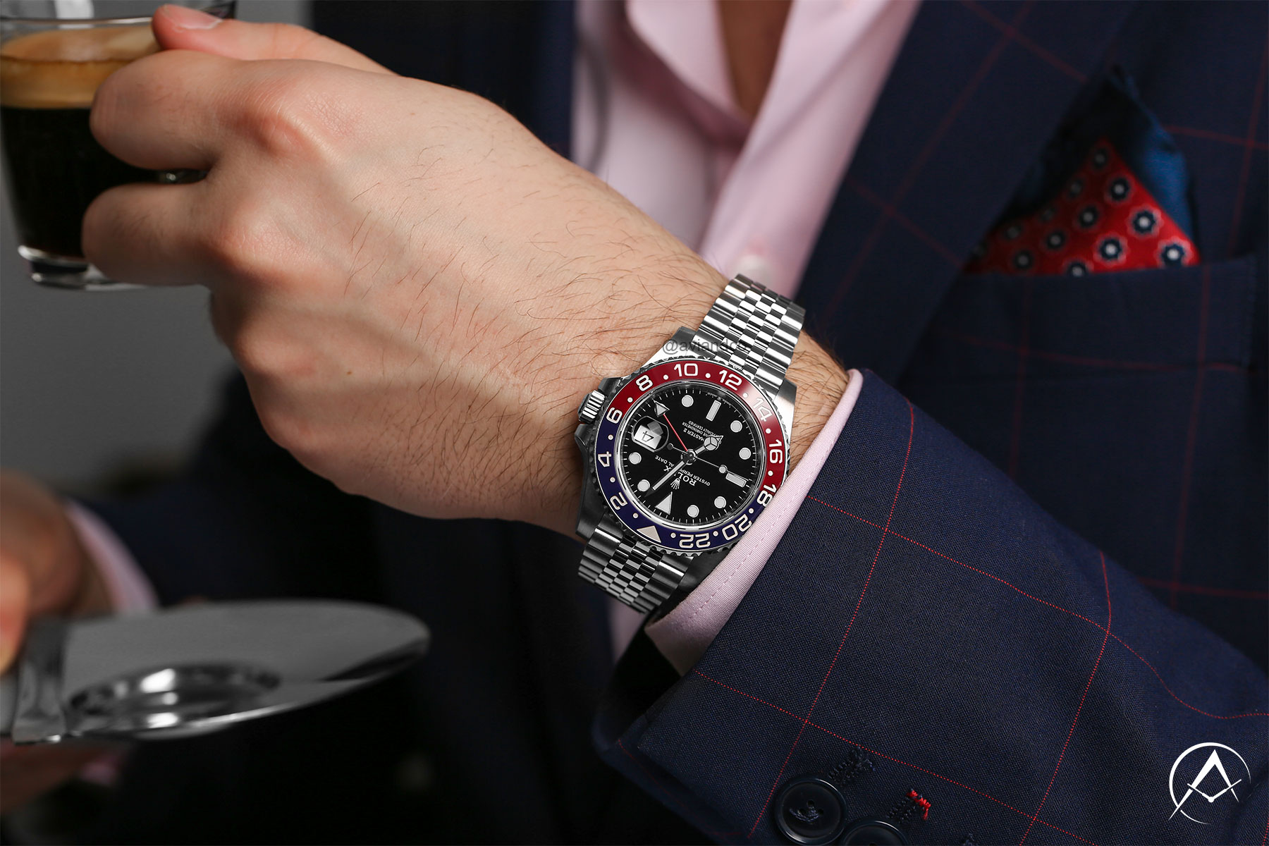 40 mm Rolex GMT-Master II Pepsi Bezel with Index Hour Markers Styled on a Man’s Wrist Wearing a Pink Button-down Shirt and Navy Blazer.