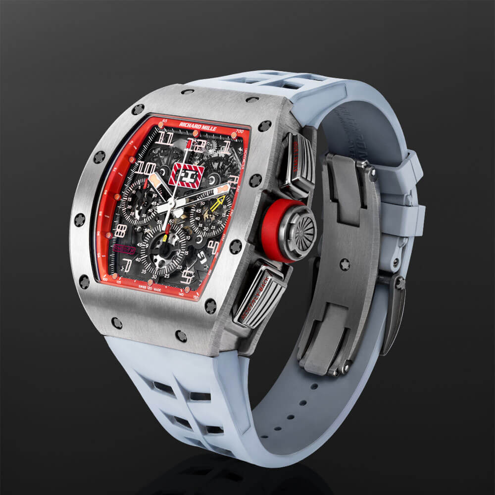 Titanium Timepiece with Light Blue Rubber Strap Displayed on a C-ring on a Black Background.