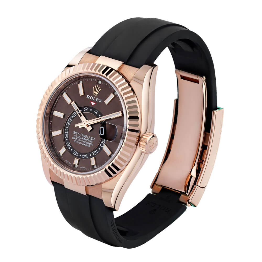 Rose Gold 42 mm Rolex Sky-Dweller Timepiece with Brown Dial and Black Strap Displayed on a Clear C-Ring on a White Background.