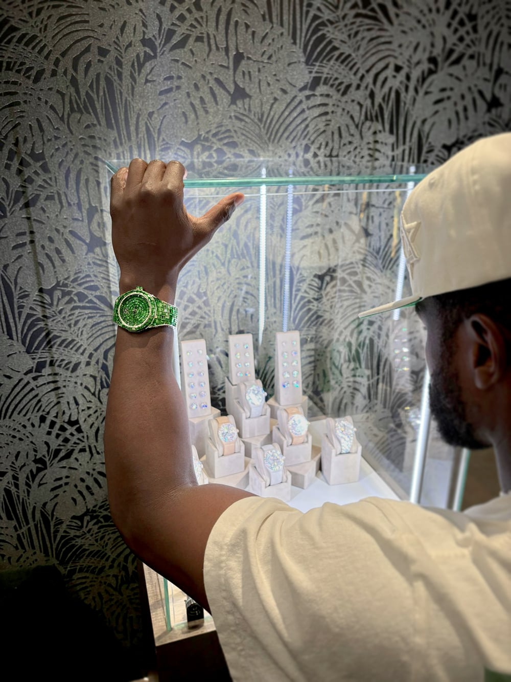 Floyd Mayweather wearing his Avi & Co. Hue Collection green tsavorite watch