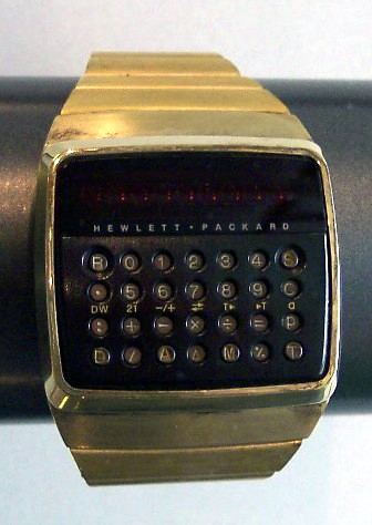 Golden Rectangular-shaped Calculator Timepiece On a Bronze Holder.