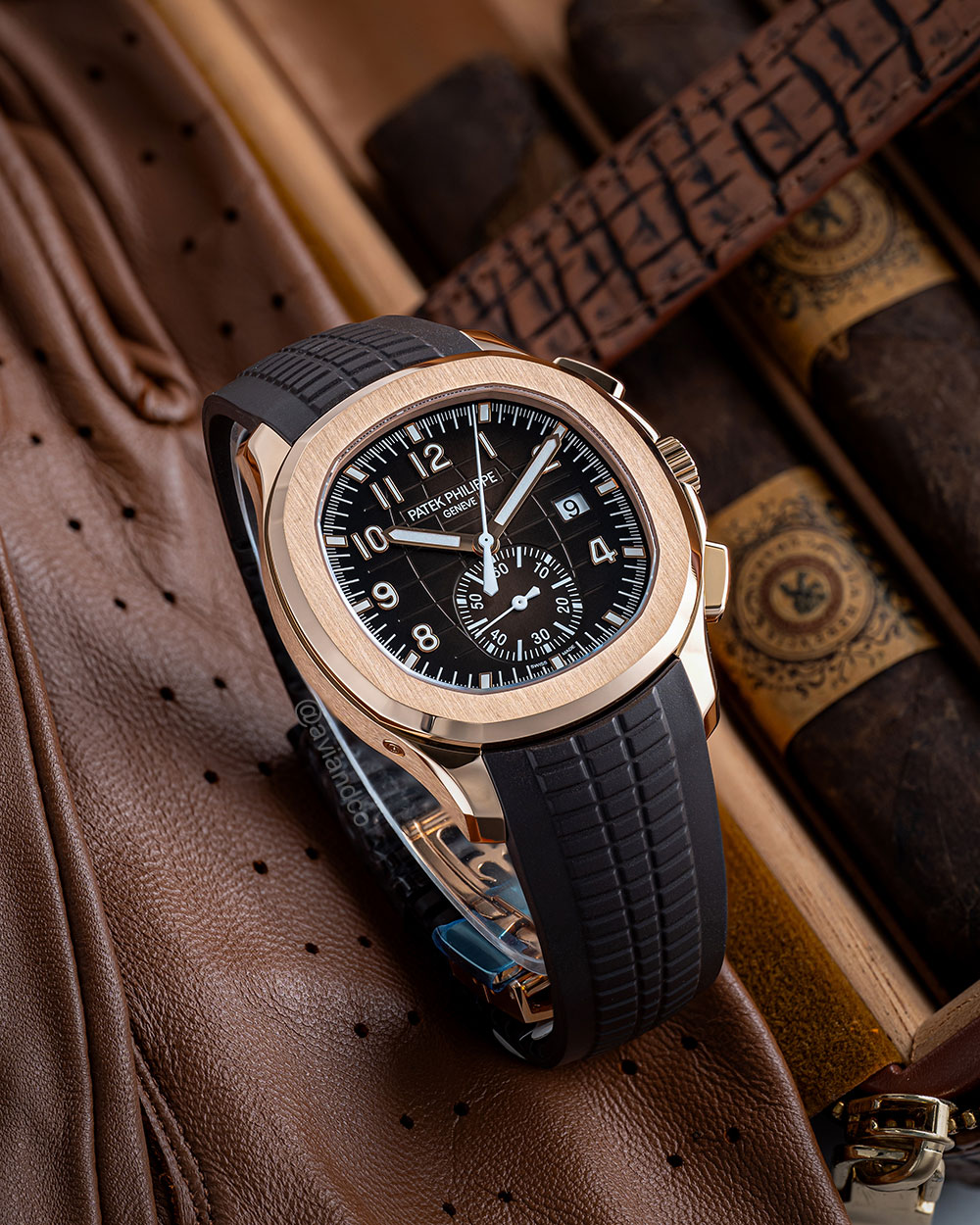 Avi & Co. Patek Philippe watch with black band, rose gold case, and brown dial