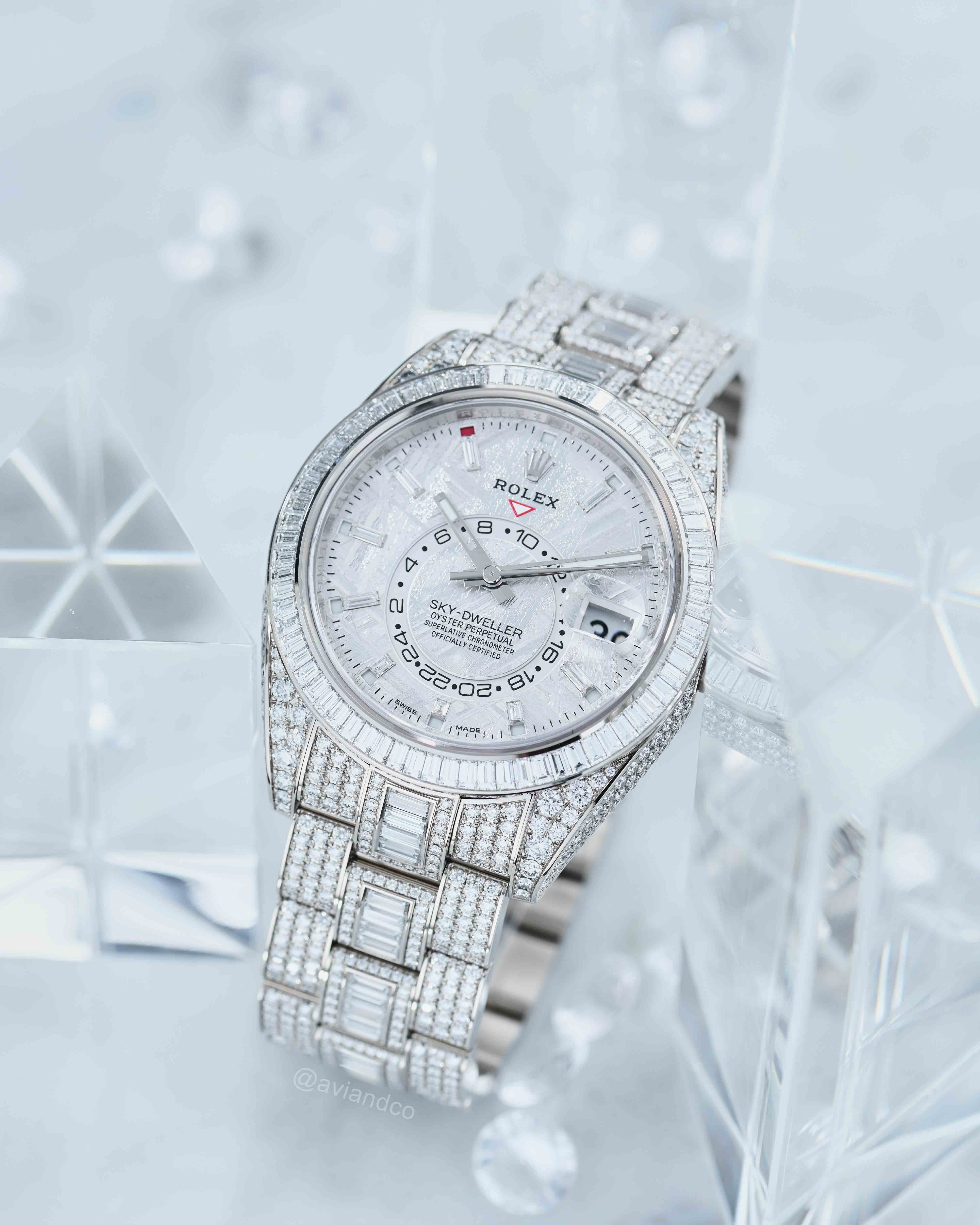 White Dial and Pave Diamond Timepiece on a Clear Snowy-Colored Background.